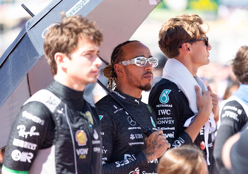 Oct 22, 2023; Austin, Texas, USA;  From left, Charles Leclerc of Ferrari, Lewis Hamilton and Mercedes teammate George Russell before the start of the Formula 1 United States Grand Prix at Circuit of the Americas. Mandatory Credit: Erich Schlegel-USA TODAY Sports