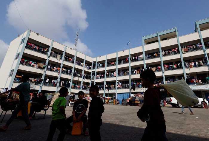 Palestinians, who fled their houses amid Israeli strikes, shelter at a United Nations-run school, after Israels call for more than 1 million civilians in northern Gaza to move south, in Khan Younis in the southern Gaza Strip, October 14, 2023. REUTERS/Ibraheem Abu Mustafa