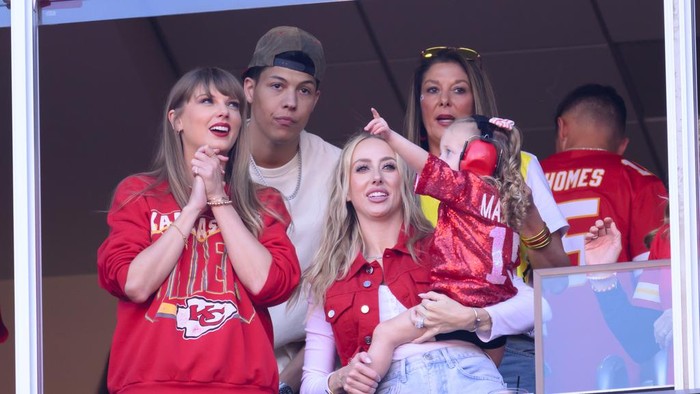 Taylor Swift, left, and Brittany Mahomes, right, watch an NFL football game between the Kansas City Chiefs and the Los Angeles Chargers with Jackson Mahomes, back left and Randi Mahomes, back right (Patrick Mahomes mother), Sunday, Oct. 22, 2023 in Kansas City, Mo. (AP Photo/Reed Hoffmann)