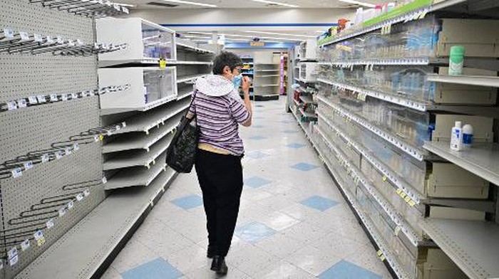 A woman browses through what items remain on near empty shelves at a Rite Aid store in Alhambra, California, on October 18, 2023, that is due for closure next Monday. The US pharmacy chain this week filed for Chapter 11 and plans to close almost 100 stores nationwide, including 31 in California, as part of its restructuring plan after filing for bankruptcy. (Photo by Frederic J. BROWN / AFP)