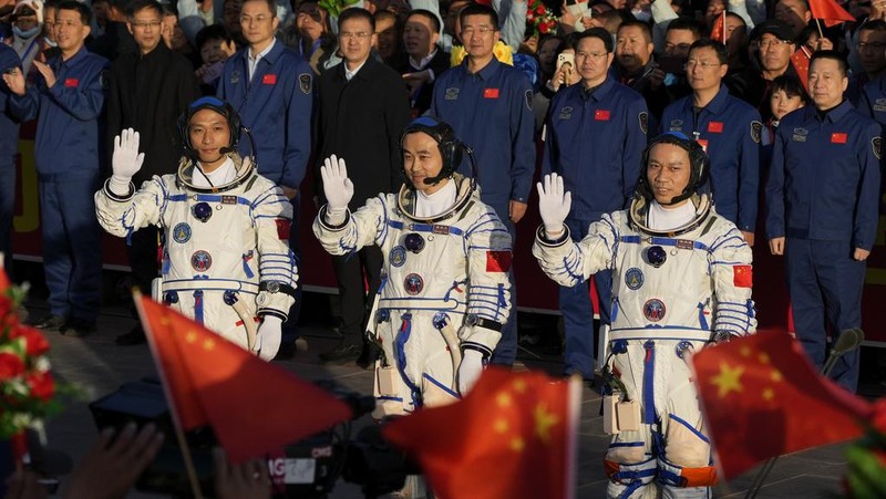 Chinese astronauts for the Shenzhou-17 mission, from left, Jiang Xinlin, Tang Hongbo and Tang Shengjie wave as they arrive for a send-off ceremony for their manned space mission at the Jiuquan Satellite Launch Center in northwestern China, Thursday, Oct. 26, 2023. (AP Photo/Andy Wong)