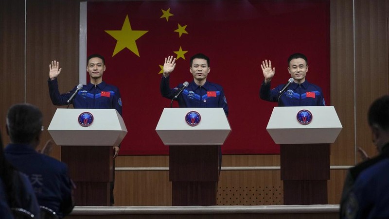 Chinese astronauts for the Shenzhou-17 mission, from left, Jiang Xinlin, Tang Hongbo and Tang Shengjie wave as they arrive for a send-off ceremony for their manned space mission at the Jiuquan Satellite Launch Center in northwestern China, Thursday, Oct. 26, 2023. (AP Photo/Andy Wong)