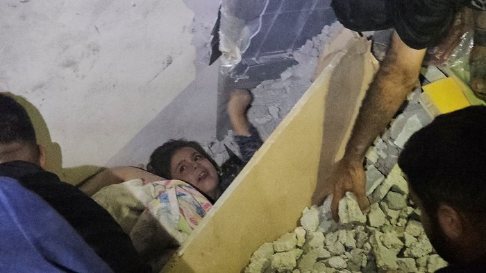 Palestinians work to rescue a boy trapped in the rubble following an Israeli strike on a house in Jabalia in the northern Gaza Strip, October 19, 2023. REUTERS/Anas al-Shareef
