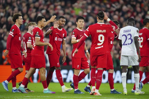 Liverpool players celebrate after Liverpools Wataru Endo, centre, scored his sides second goal during the Europa League Group E soccer match between Liverpool and Toulouse, at Anfield in Liverpool, England, Thursday, Oct. 26, 2023. (AP Photo/Jon Super)