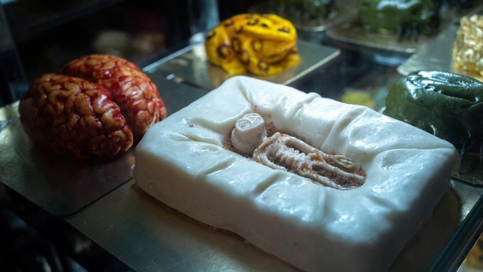 A ‘non-human’ being cake and a brain cake are displayed inside a refrigerator at the Vetmon (Magic) cafe in Bangkok, Thailand, October 18, 2023. REUTERS/Athit Perawongmetha
