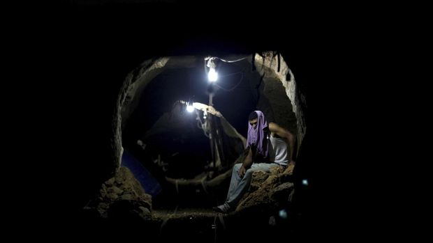 FILE - A Palestinian worker rests inside a smuggling tunnel in Rafah, on the border between Egypt and the southern Gaza Strip Sept. 30, 2013. An extensive labyrinth of tunnels built by Hamas stretches across the dense neighborhoods of the Gaza Strip, hiding militants, their missile arsenal and the over 200 hostages they now hold after an unprecedented Oct. 7, 2023, attack on Israel. (AP Photo/Hatem Moussa, File)