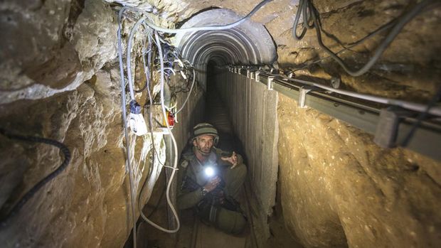 FILE - An Israeli army officer gives journalists a tour, Friday, July 25, 2014, of a tunnel allegedly used by Palestinian militants for cross-border attacks, at the Israel-Gaza Border.  An extensive labyrinth of tunnels built by Hamas stretches across the dense neighborhoods of the Gaza Strip, hiding militants, their missile arsenal and the over 200 hostages they now hold after an historic Oct.  7, 2023, attack on Israel.  (AP Photo/Jack Guez, Pool, File)