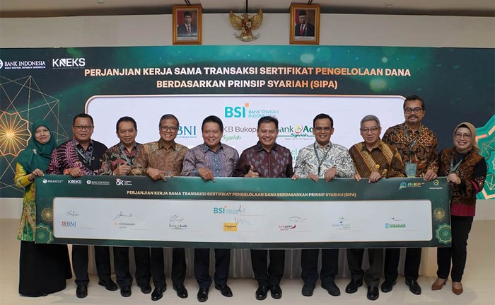 BSI Optimalkan Sinergi Bersama 15 Lembaga Keuangan Direktur Utama BSI yang juga Ketua Umum Asbisindo Hery Gunardi (kelima kiri), Direktur Departemen Ekonomi dan Keuangan Syariah Bank Indonesia (BI) Wahyu Purnama (kelima kanan), Direktur Treasuary & International Banking BSI Moh Adib (keempat kiri) bersama perwakilan perbankan syariah lainnya saat penandatangan kerja sama transaksi Sertifikat Pengelolaan Dana Berdasarkan Prinsip Syariah Antarbank (SiPA) dirangkaian acara ISEFdalam rangka Bulan Pembiayaan Syariah di JCC Senayan Jakarta, Jumat (27/10).