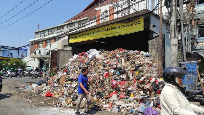 Sampah berjibun hingga ke jalan di Depo Sampah Jalan Pulau Seram, Desa Dauh Puri Kelod, tepatnya di sebelah pintu barat Level Twenty One Mall, Kota Denpasar. Warga yang melintas di depan TPS dengan berjalan kaki harus memakai badan jalan.