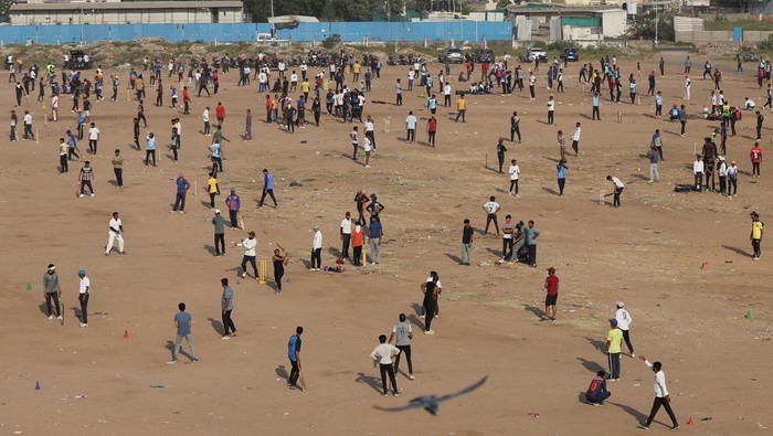 Men play cricket in an open space on the outskirts of Ahmedabad, India, October 29, 2023. REUTERS/Amit Dave