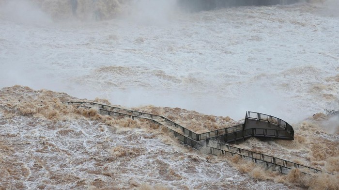People look at Iguazu Falls, where the water level has risen due to the heavy rains that hit the southern region of Brazil, in Foz do Iguacu, Parana State, Brazil October 30, 2023. REUTERS/Kiko Sierich NO RESALES. NO ARCHIVES