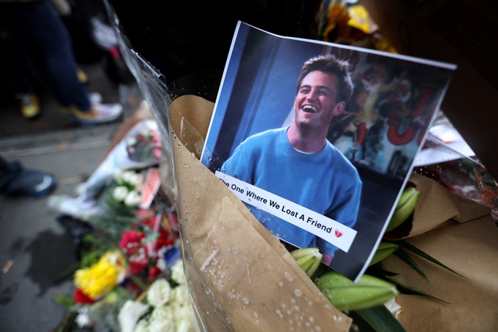 People gather near a makeshift memorial for actor Matthew Perry, the wise-cracking co-star of the 1990s hit television sitcom 