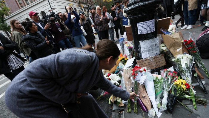 People gather near a makeshift memorial for actor Matthew Perry, the wise-cracking co-star of the 1990s hit television sitcom 