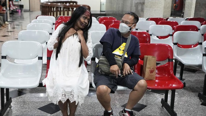A staffer for the National Blood Center dressed in ghost costumes sits next to a blood donor at the center during a Halloween in Bangkok, Thailand, Tuesday, Oct. 31, 2023. The center encourages people to donate their blood in a Halloween-themed campaign. (AP Photo/Sakchai Lalit)