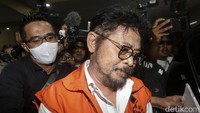 Mereka keluar dengan tangan diborgol besi dan rompi tahanan oranye. Meski diikuti hingga masuk ke dalam mobil, SYL tetap bungkam.
