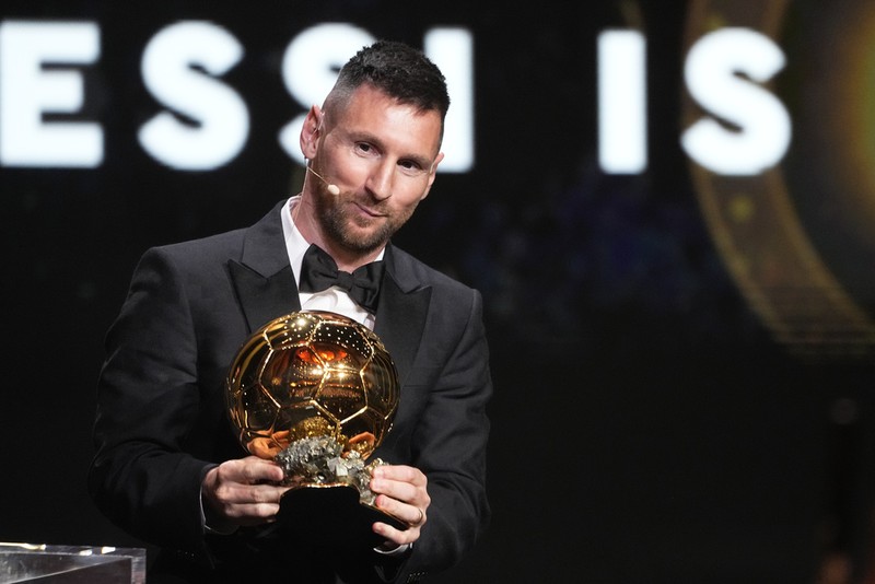 Inter Miami's and Argentina's national team player Lionel Messi receives the 2023 Ballon d'Or trophy during the 67th Ballon d'Or (Golden Ball) award ceremony at Theatre du Chatelet in Paris, France, Monday, Oct. 30, 2023. (AP Photo/Michel Euler)