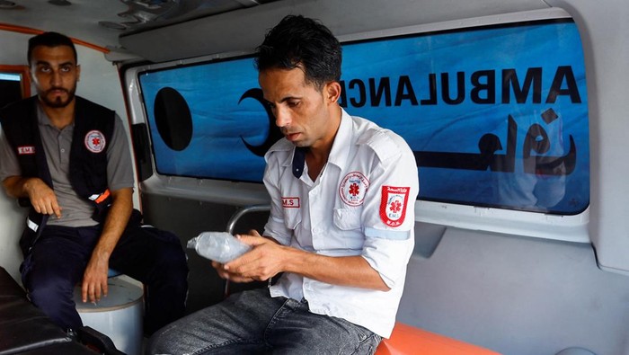 Palestinian volunteer paramedic Loay Al-Astal sits in an ambulance at Nasser hospital, amid the ongoing conflict between Israel and Hamas, in Khan Younis in the southern Gaza Strip October 29, 2023. REUTERS/Ibraheem Abu Mustafa
