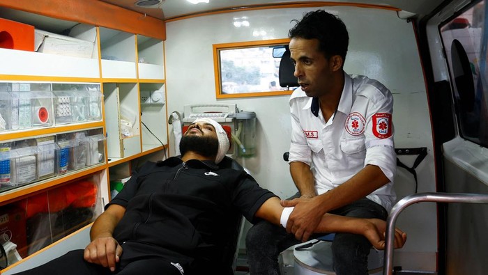 Palestinian volunteer paramedic Loay Al-Astal sits in an ambulance at Nasser hospital, amid the ongoing conflict between Israel and Hamas, in Khan Younis in the southern Gaza Strip October 29, 2023. REUTERS/Ibraheem Abu Mustafa