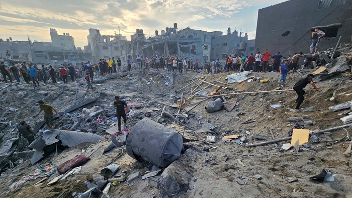 SENSITIVE MATERIAL. THIS IMAGE MAY OFFEND OR DISTURB    A Palestinian man carries the body of a child killed in Israeli strikes, in Jabalia refugee camp, in the northern Gaza Strip October 9, 2023. REUTERS/Mahmoud Issa    NO RESALES. NO ARCHIVES.      TPX IMAGES OF THE DAY