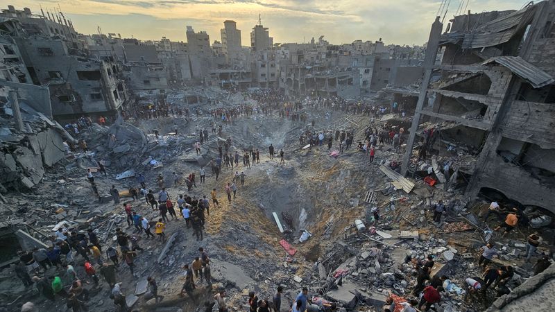SENSITIVE MATERIAL. THIS IMAGE MAY OFFEND OR DISTURB    A Palestinian man carries the body of a child killed in Israeli strikes, in Jabalia refugee camp, in the northern Gaza Strip October 9, 2023. REUTERS/Mahmoud Issa    NO RESALES. NO ARCHIVES.      TPX IMAGES OF THE DAY