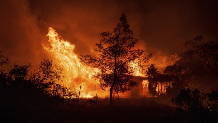 A structure is engulfed in flames as a wildfire called the Highland Fire burns in Aguanga, Calif., Monday, Oct. 30, 2023. A wildfire fueled by gusty Santa Ana winds ripped through rural land southeast of Los Angeles on Monday, forcing thousands of people from their homes, fire authorities said. (AP Photo/Ethan Swope)