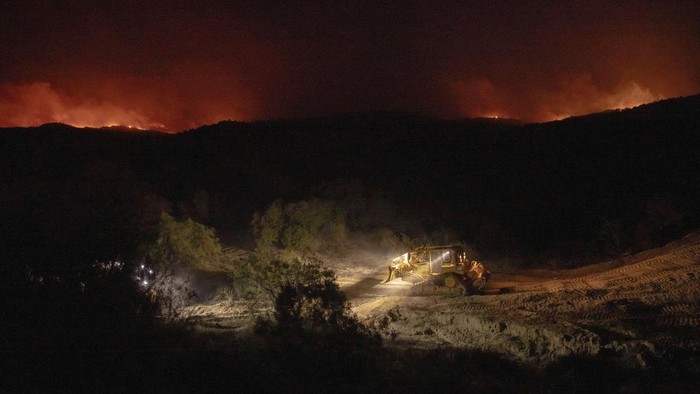 A structure is engulfed in flames as a wildfire called the Highland Fire burns in Aguanga, Calif., Monday, Oct. 30, 2023. A wildfire fueled by gusty Santa Ana winds ripped through rural land southeast of Los Angeles on Monday, forcing thousands of people from their homes, fire authorities said. (AP Photo/Ethan Swope)