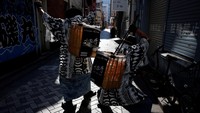 Mengenakan topi dan tunik hitam-putih bermotif berani, kelompok tersebut dikenal sebagai Gomihiroi Samurai atau samurai pemulung.  