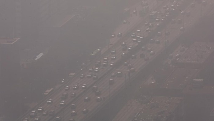 People wearing face masks wait at an intersection in Beijing's Central Business District (CBD), as the city is shrouded in smog, in China November 1, 2023. REUTER/Tingshu Wang