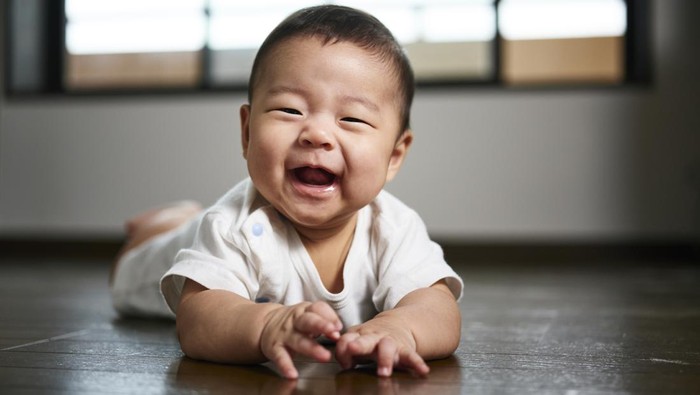Baby with toy and doll