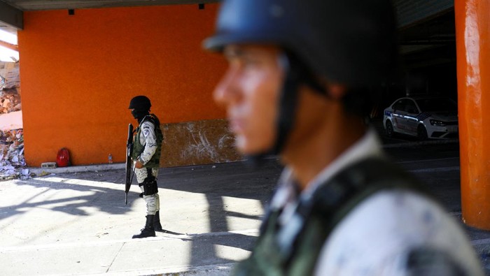 Cegah Penjarahan, SPBU-Mal di Meksiko Dijaga Tentara An employee cleans at a shopping centre in the aftermath of Hurricane Otis, in Acapulco, Mexico, November 2, 2023. REUTERS/Jose Luis Gonzalez
