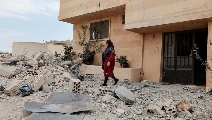 Hiba, 28, walks amid rubble after her family house was damaged, by what she said was an Israeli shell, amidst tension between Israel and Hezbollah, in the southern town of Yater, Lebanon November 1, 2023. REUTERS/Zohra Bensemra