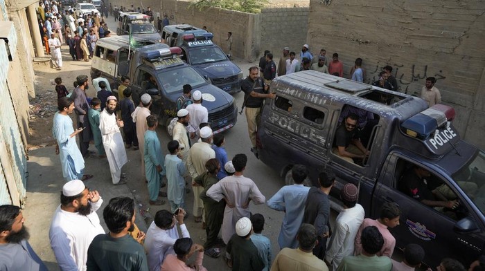 Detained immigrants, who fail to provide legal documents, are transported by police in a bus to shift them in a deportation center in Karachi, Pakistan, Thursday, Nov. 2, 2023. Pakistani security forces rounded up, detained and deported dozens of Afghans who were living in the country illegally, after a government-set deadline for them to leave expired, authorities said. (AP Photo/Fareed Khan)