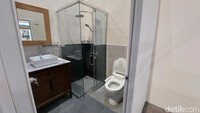 Foto: Almadinah Putri BrilianDi dalam kamar mandi cukup lengkap, ada shower, toilet, wastafel, cermin, dan sebuah lemari kecil di bawah wastafel.