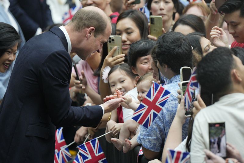 Britain's Prince William, left, is greeted by public as he arrives at Jewel Changi airport, Singapore, Sunday, Nov. 5, 2023. (AP Photo/Vincent Thian)