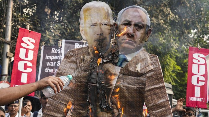Activists of Socialist Unity Center of India (Communist) burn an effigy of U.S. President Joe Biden and Israeli Prime Minister Benjamin Netanyahu during a rally to protest against Israel's military operations in Gaza and to show solidarity with the Palestinian people, in Kolkata, India, Wednesday, Nov. 1, 2023. (AP Photo/Bikas Das)