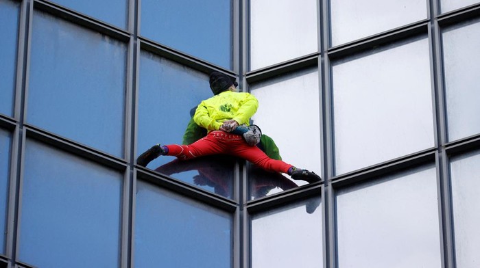 French skyscraper climber Alain Robert climbs the Tour TotalEnergies Coupole skyscraper to call for 