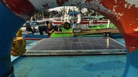 Nelayan membersihkan panel surya sebelum melaut di kawasan Pelabuhan Baai, Bengkulu, Rabu (8/11/2023).  