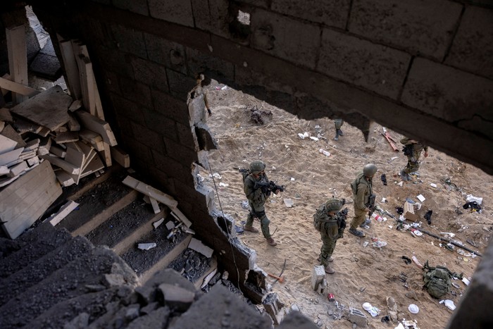Israeli soldiers walk through rubble, amid the ongoing ground invasion against Palestinian Islamist group Hamas in the northern Gaza Strip, November 8, 2023. REUTERS/Ronen Zvulun.  EDITOR’S NOTE: REUTERS PHOTOGRAPHS WERE REVIEWED BY THE IDF AS PART OF THE CONDITIONS OF THE EMBED. NO PHOTOS WERE REMOVED.