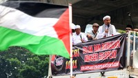 Salah satu peserta mengibarkan bendera Palestina di sela-sela aksi tersebut.  