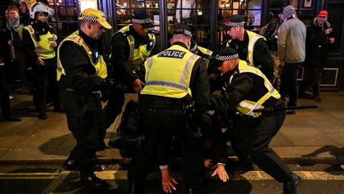 Police officers detain a man in the street by Whitehall close to the National March For Palestine in central London on November 11, 2023, as counter-protest groups are monitored by police close to the route of the main march. About 300,000 people marched through the British capital, as pro-Palestinian supporters made a new call for a Gaza war ceasefire. Authorities had feared trouble as the 