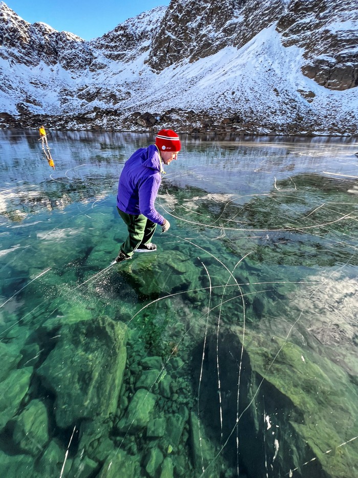 A man skates over a rare ice window created due to frozen alpine lakes in Rabbit Lake, Alaska, U.S., October 26, 2023, in this picture obtained from social media. Luc Mehl/via REUTERS  THIS IMAGE HAS BEEN SUPPLIED BY A THIRD PARTY. MANDATORY CREDIT. NO RESALES. NO ARCHIVES.
