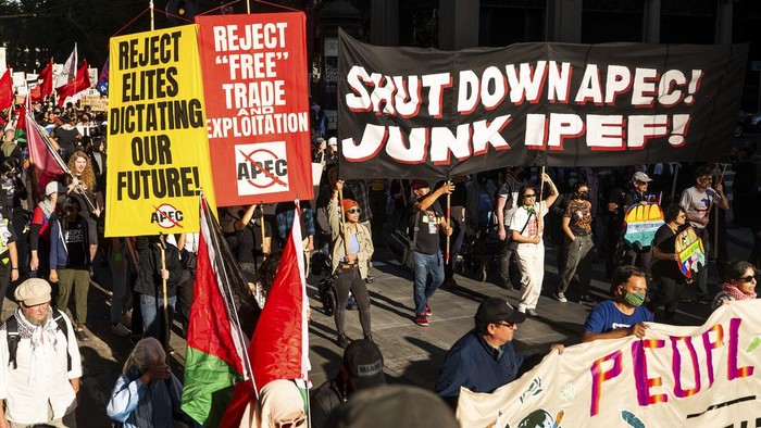 Protesters march along Market Street while demonstrating against the APEC (Asia-Pacific Economic Cooperation) Summit, Sunday, Nov. 12, 2023, in San Francisco. Hundreds of business executives, foreign press and world leaders will descend on San Francisco for the highly anticipated global trade summit. (AP Photo/Noah Berger)