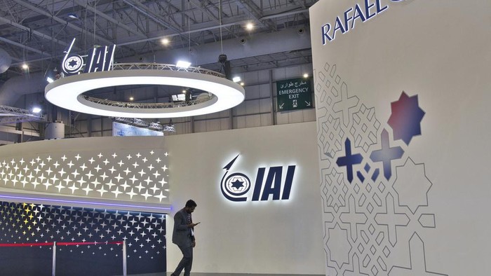 Emiratis walk past the empty stand of Israel Aerospace Industries at the Dubai Air Show in Dubai, United Arab Emirates, Monday, Nov. 13, 2023. The biennial Dubai Air Show opened Monday as airlines are poised to make major aircraft purchases after rebounding from the groundings of the coronavirus pandemic, even as Israel's war with Hamas clouds regional security. (AP Photo/Jon Gambrell)