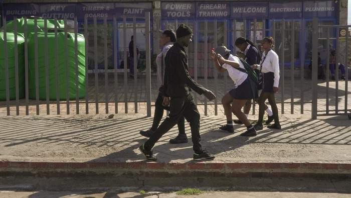 A group of school children from Ubusi Combined School play along the way as they prepare to embark on their walk back to their various homes at the end of the day near Dundee, South Africa, Thursday, Oct. 26, 2023. Thousands of children in South Africas poorest and most remote rural communities still face a miles-long walk to school, nearly 30 years after the country ushered in democratic change. (AP Photo/ Sebabatso Mosamo)