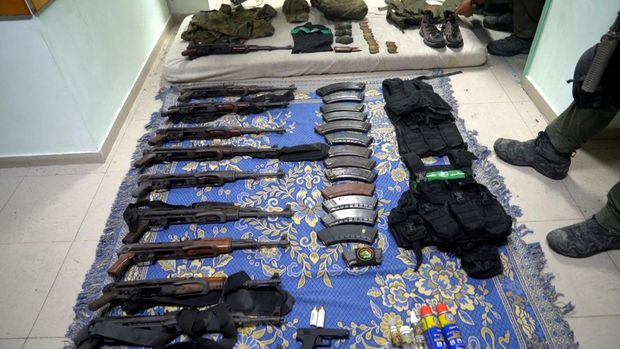 An Israeli officer shows a rifle that he says was discovered in a bag stored in a cabinet containing medical supplies at the Al Shifa hospital complex, amid the Israeli military's ground operation against Palestinian Islamist group Hamas, in Gaza City, November 15, 2023 in this still image taken from video. Israeli forces said the 