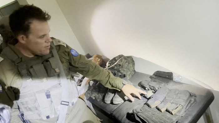 An Israeli officer shows a rifle that he says was discovered in a bag stored in a cabinet containing medical supplies at the Al Shifa hospital complex, amid the Israeli militarys ground operation against Palestinian Islamist group Hamas, in Gaza City, November 15, 2023 in this still image taken from video. Israeli forces said the 