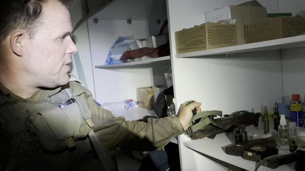An Israeli officer shows a rifle that he says was discovered in a bag stored in a cabinet containing medical supplies at the Al Shifa hospital complex, amid the Israeli military's ground operation against Palestinian Islamist group Hamas, in Gaza City, November 15, 2023 in this still image taken from video. Israeli forces said the 