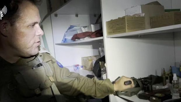 A member of Israel's army shows weapons and equipment which they say were found at Al Shifa hospital complex in the Gaza Strip, as seen in this screen grab taken from video released by the Israel Defense Forces on November 15, 2023. Israel Defense Forces/Handout via REUTERS Acquire Licensing Rights