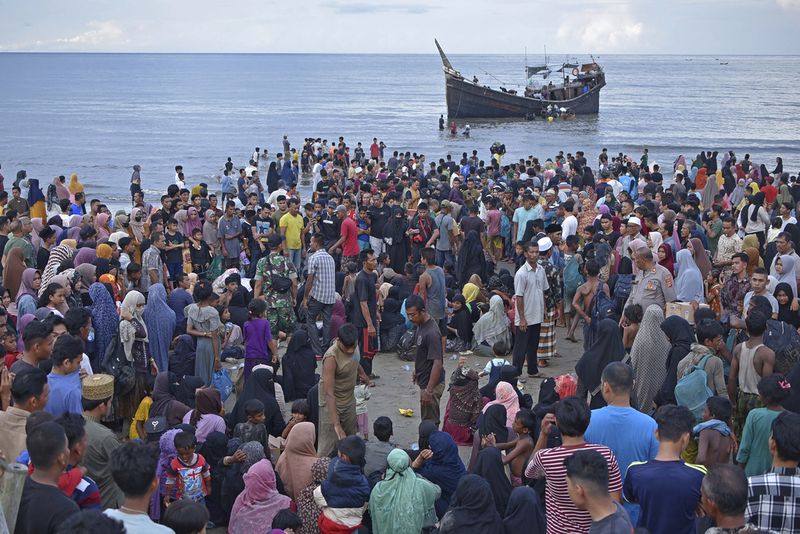 Ethnic Rohingya disembark from their boat upon landing in Ulee Madon, North Aceh, Indonesia, Thursday, Nov. 16, 2023. Some 240 Rohingya Muslims, including women and children, are afloat off the coast of Indonesia after two attempts to land were rejected by local residents. The boat left again a few hours later following the rejection. (AP Photo/Rahmat Mirza)
