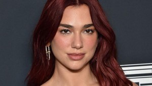 Dua Lipa tampil effortless, tapi tetap jadi pusat dunia buat Callum Turner. Foto: AFP/LISA OCONNOR